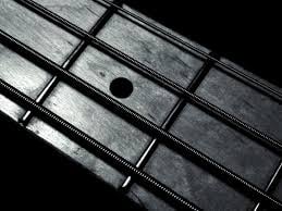 BASS GUITAR FINGERBOARD AND STRINGS.